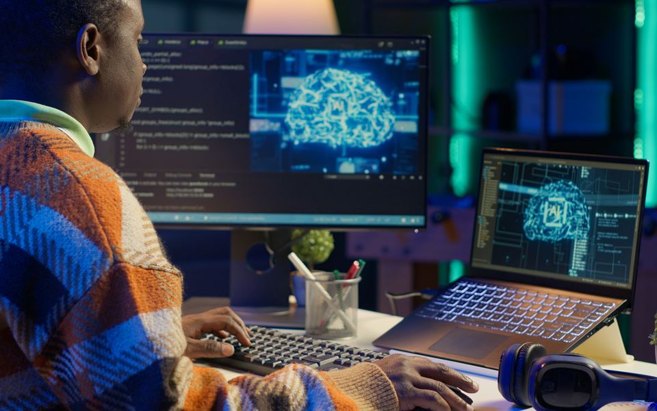 A developer reading model code beside a rendering of a neural network.